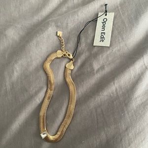 Open Edit gold choker with jewel